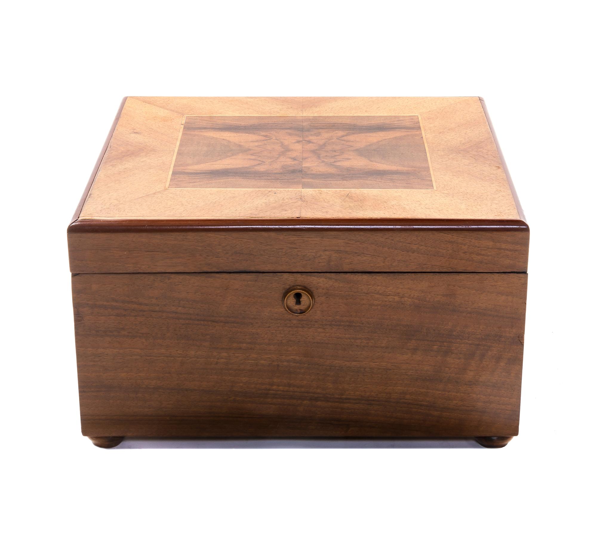 An Imperator Walnut Disk Music Box, Heigth 8 3/8 x width 13 5/8 x depth 13 1/2 inches.