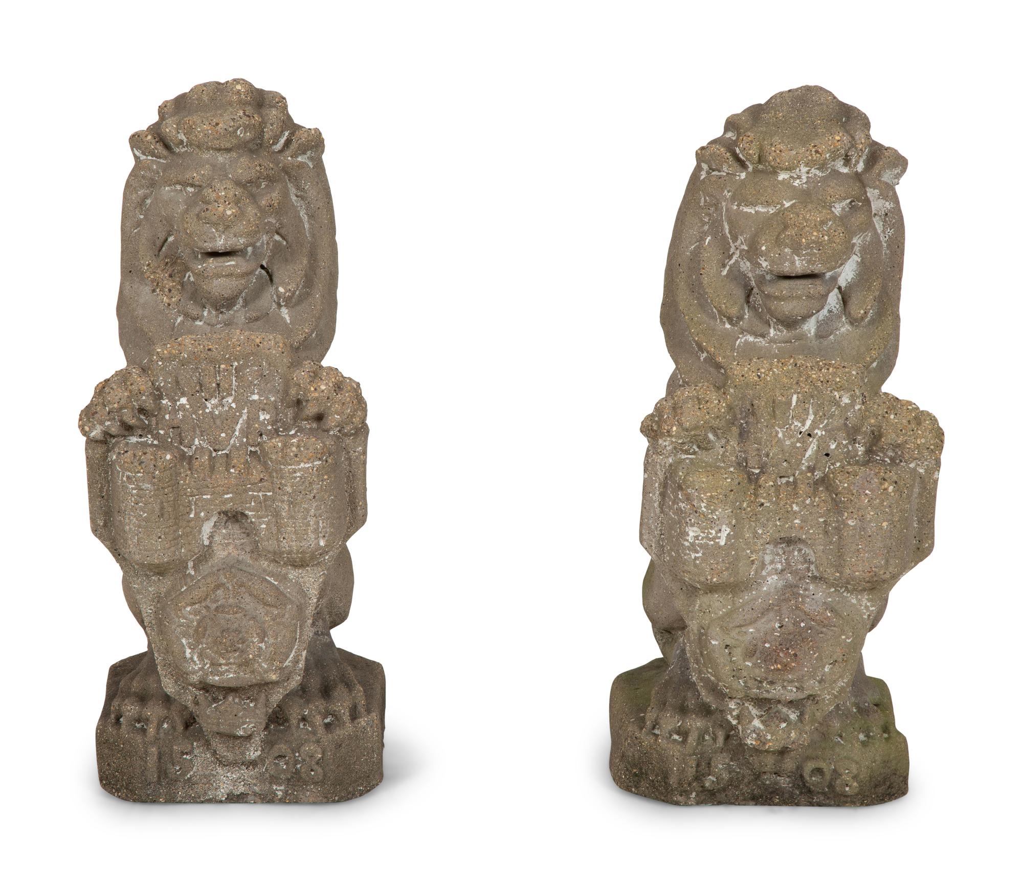 A Pair of Cast Cement Lions Holding Armorial Shields