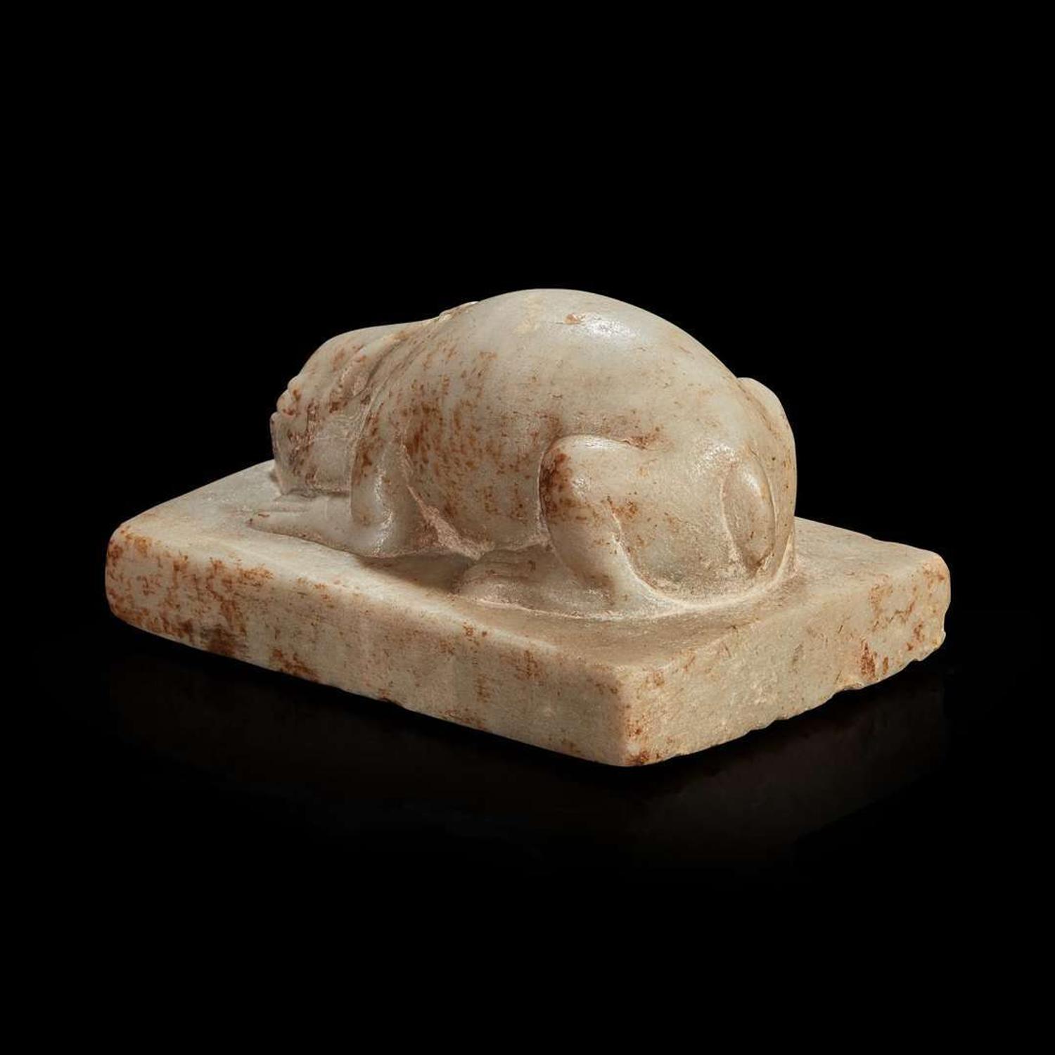 A Chinese white marble figure of a crouching rabbit Tang dynasty or later