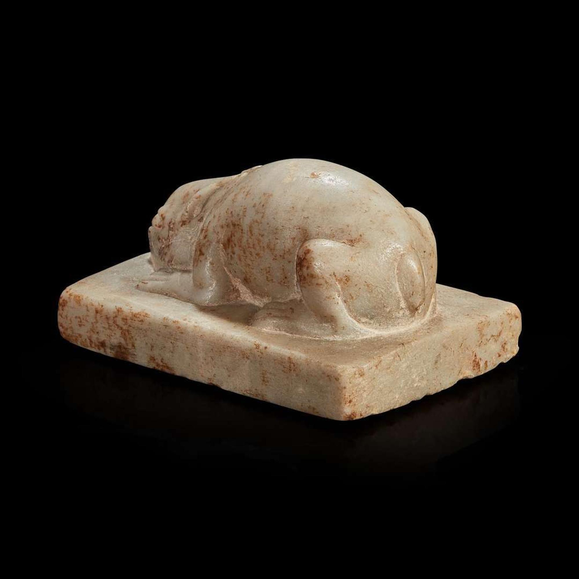 A Chinese white marble figure of a crouching rabbit Tang dynasty or later