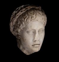 A Roman Marble Head of a Youth Wearing a Laurel Wreath