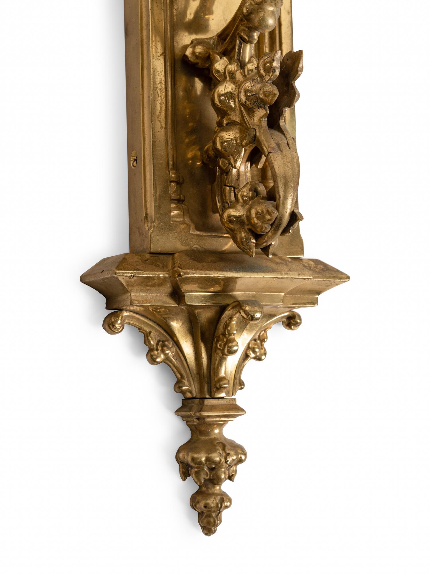 A Pair of Gothic Style Brass Three-Light Sconces