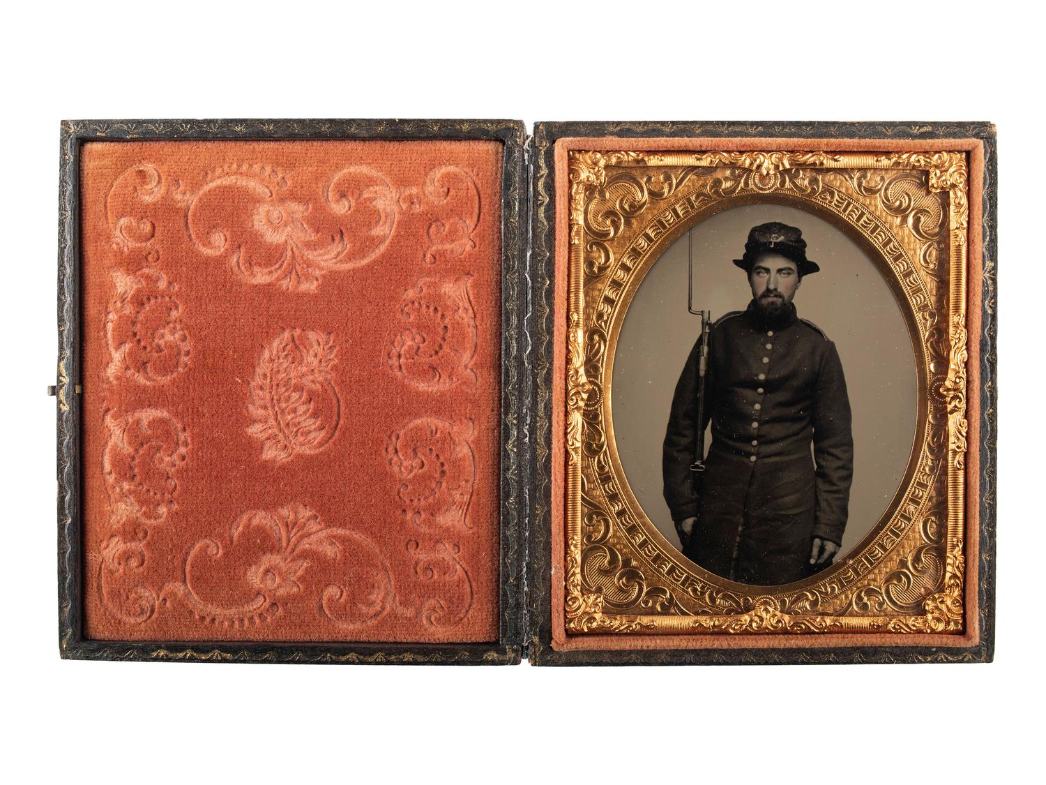 [CIVIL WAR]. Exceptionally clear sixth plate ruby ambrotype of armed New Hampshire infantryman. Ca early 1860s.