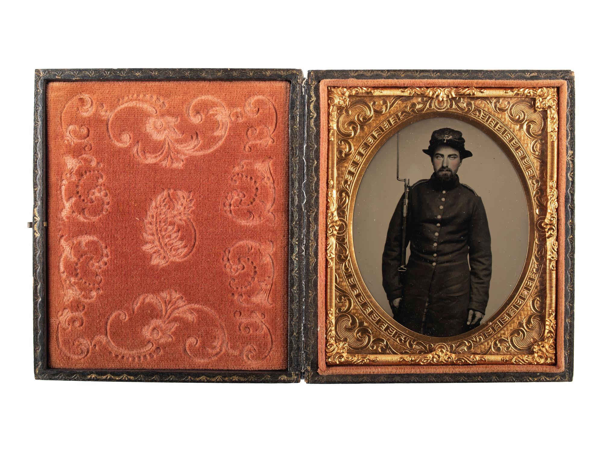 [CIVIL WAR]. Exceptionally clear sixth plate ruby ambrotype of armed New Hampshire infantryman. Ca early 1860s.