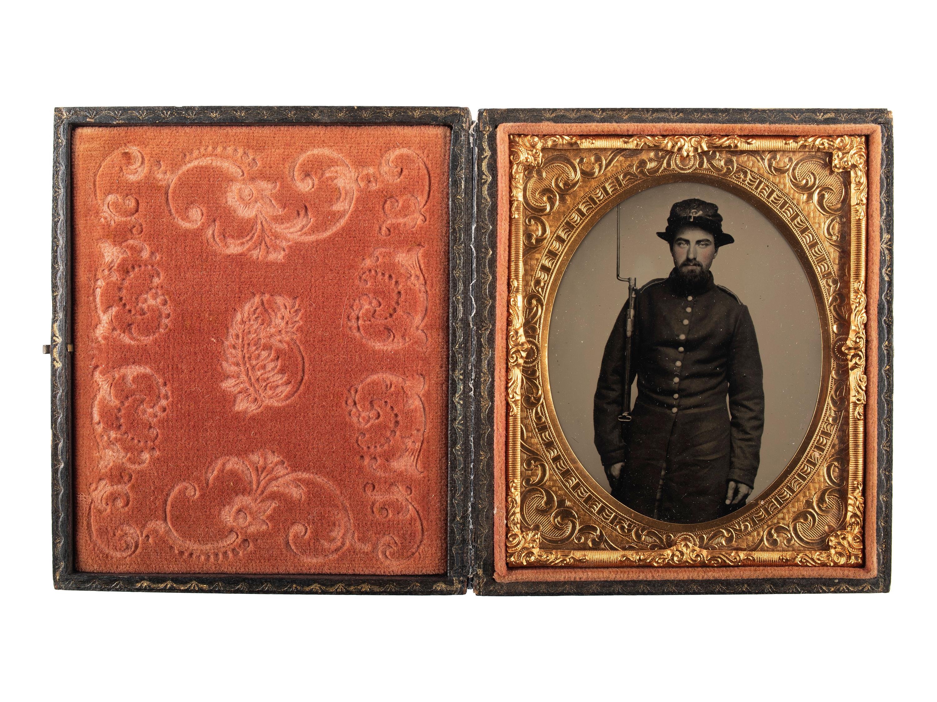 [CIVIL WAR]. Exceptionally clear sixth plate ruby ambrotype of armed New Hampshire infantryman. Ca early 1860s.