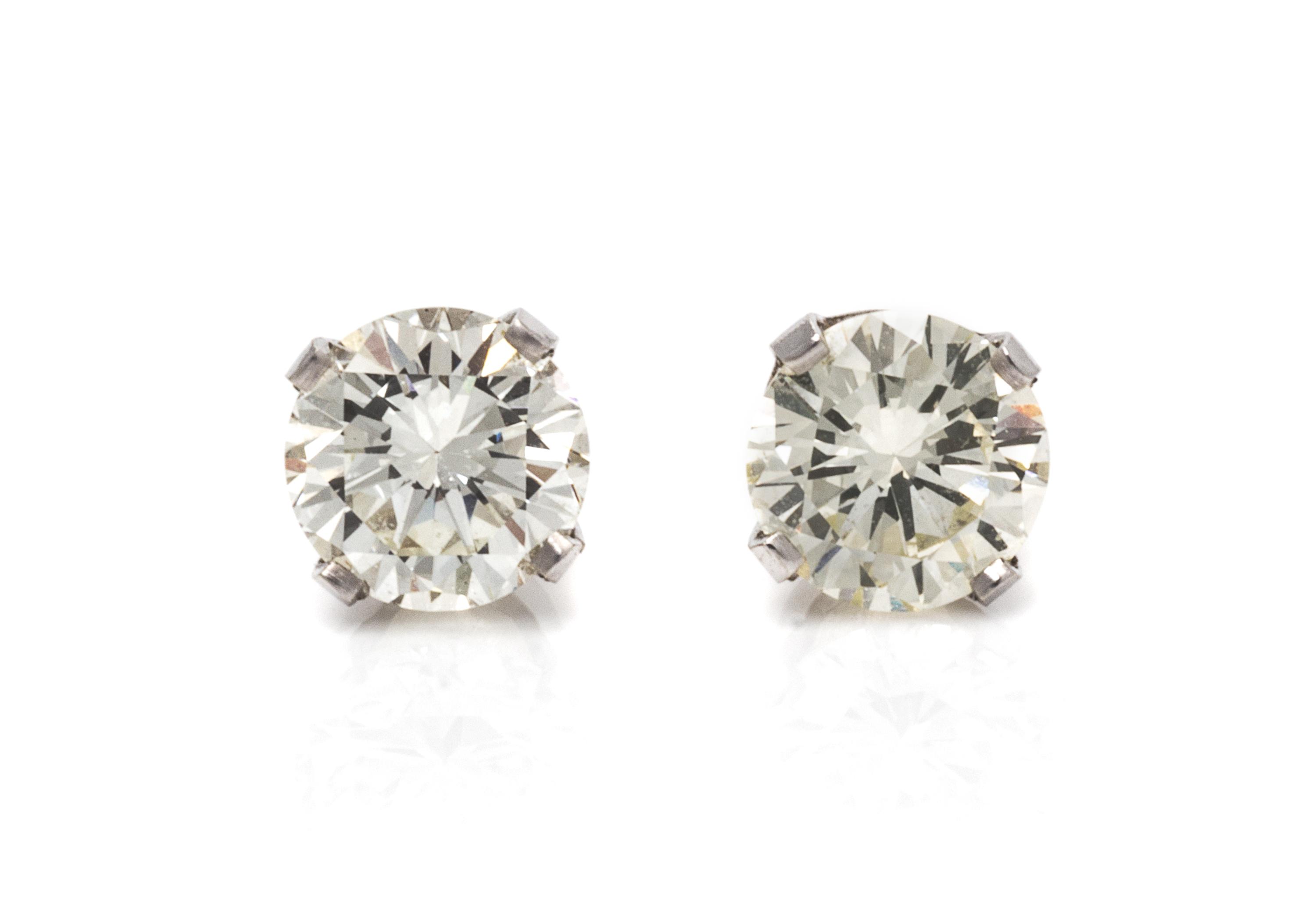 A Pair of 18 Karat White Gold and Diamond Stud Earrings, 0.80 dwts.