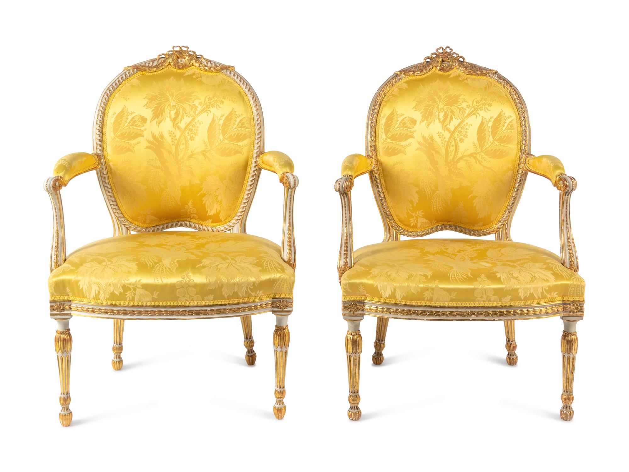 A Matched Pair of George III White-Painted and Parcel-Gilt Armchairs