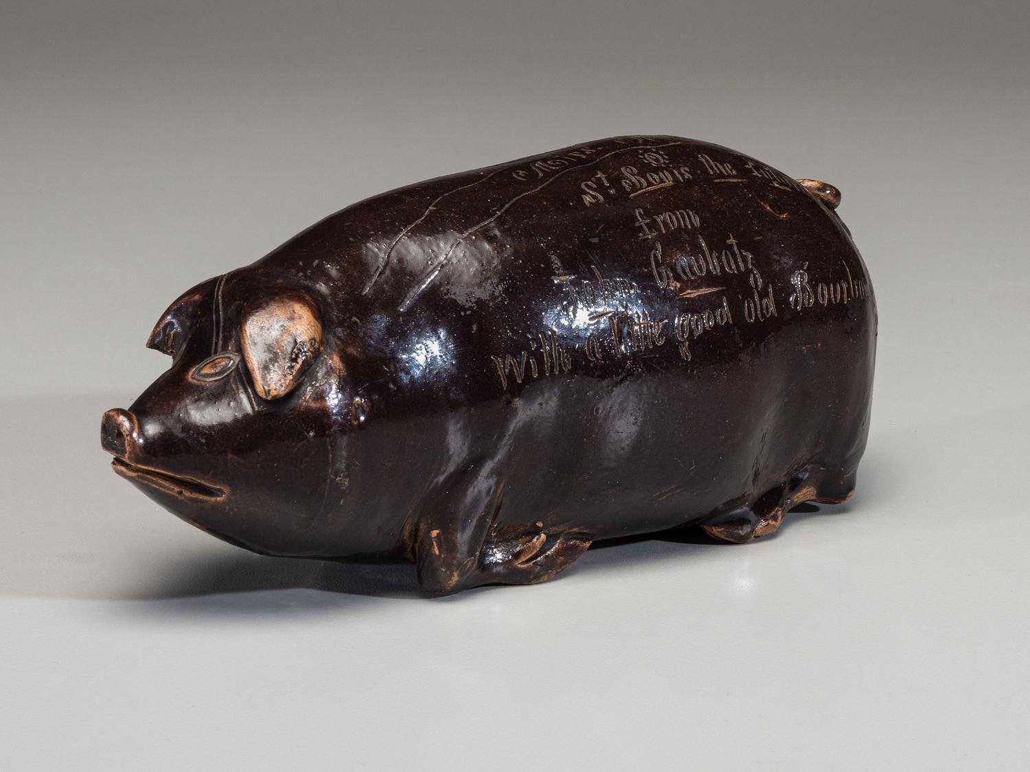 An Anna Pottery Incised and Brown Glazed Pig Flask