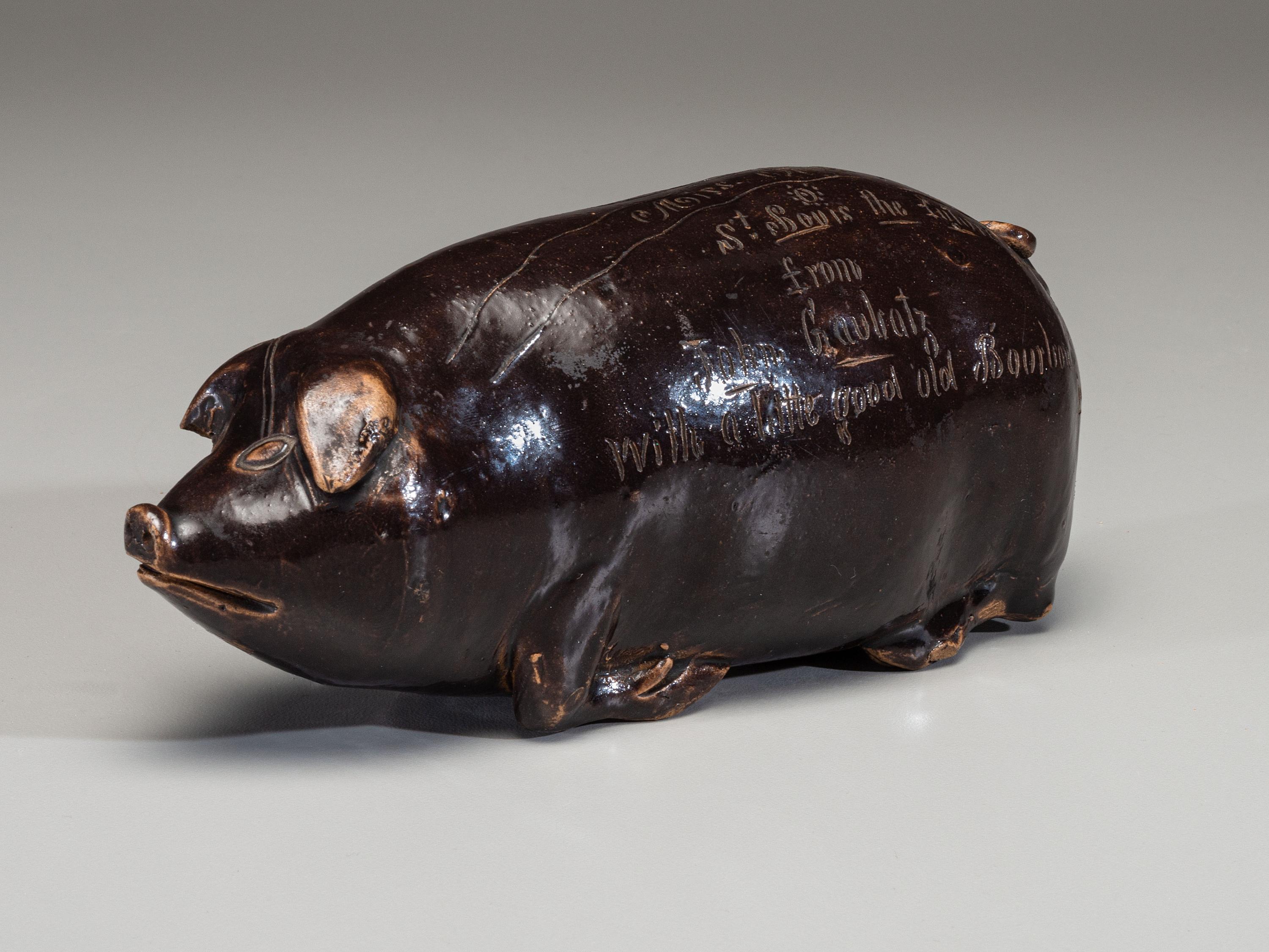 An Anna Pottery Incised and Brown Glazed Pig Flask