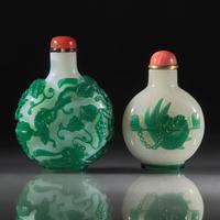 Two Chinese Green-Overlaid Glass Snuff Bottles, Qing Dynasty, 18th and 19th Centuries — 清中期 涅白地套綠料及雪霏地套綠料鼻煙壺兩支
