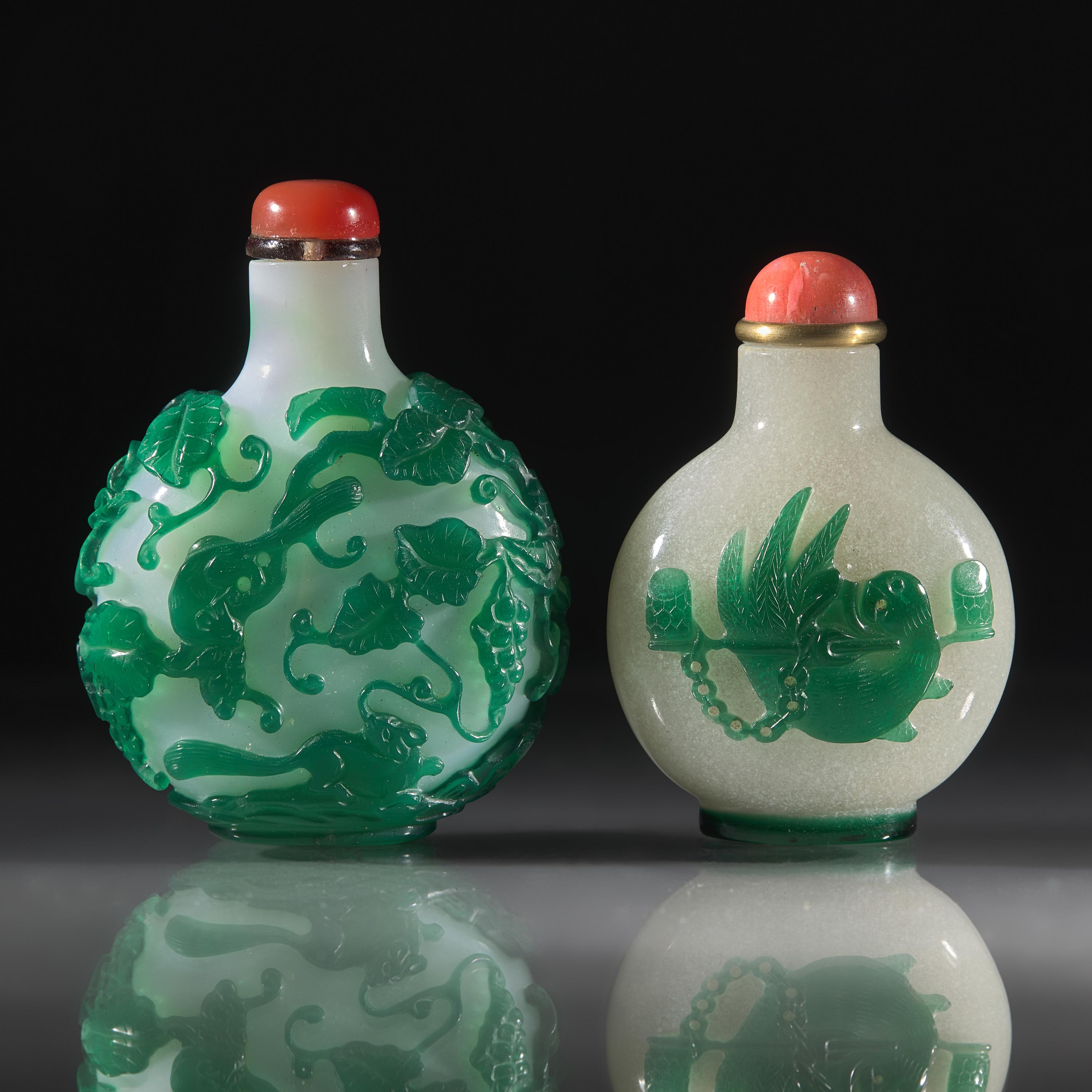Two Chinese Green-Overlaid Glass Snuff Bottles, Qing Dynasty, 18th and 19th Centuries — 清中期 涅白地套綠料及雪霏地套綠料鼻煙壺兩支
