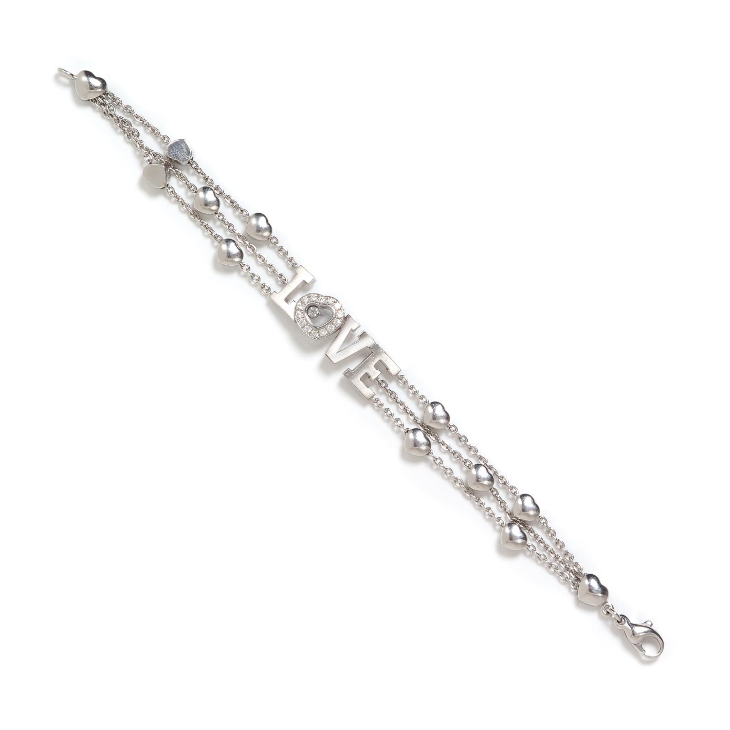 An 18 Karat White Gold and Diamond 'Happy Diamond LOVE' Bracelet, Chopard, 17.20 dwts.