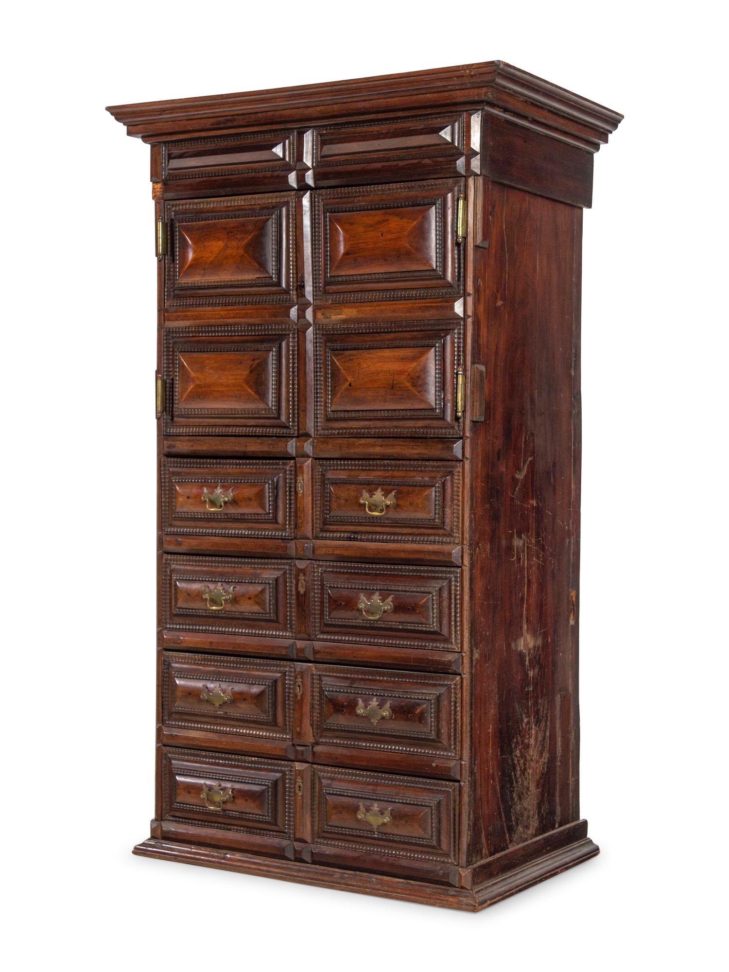 A Dutch Carved and Paneled Walnut Tall Chest of Drawers