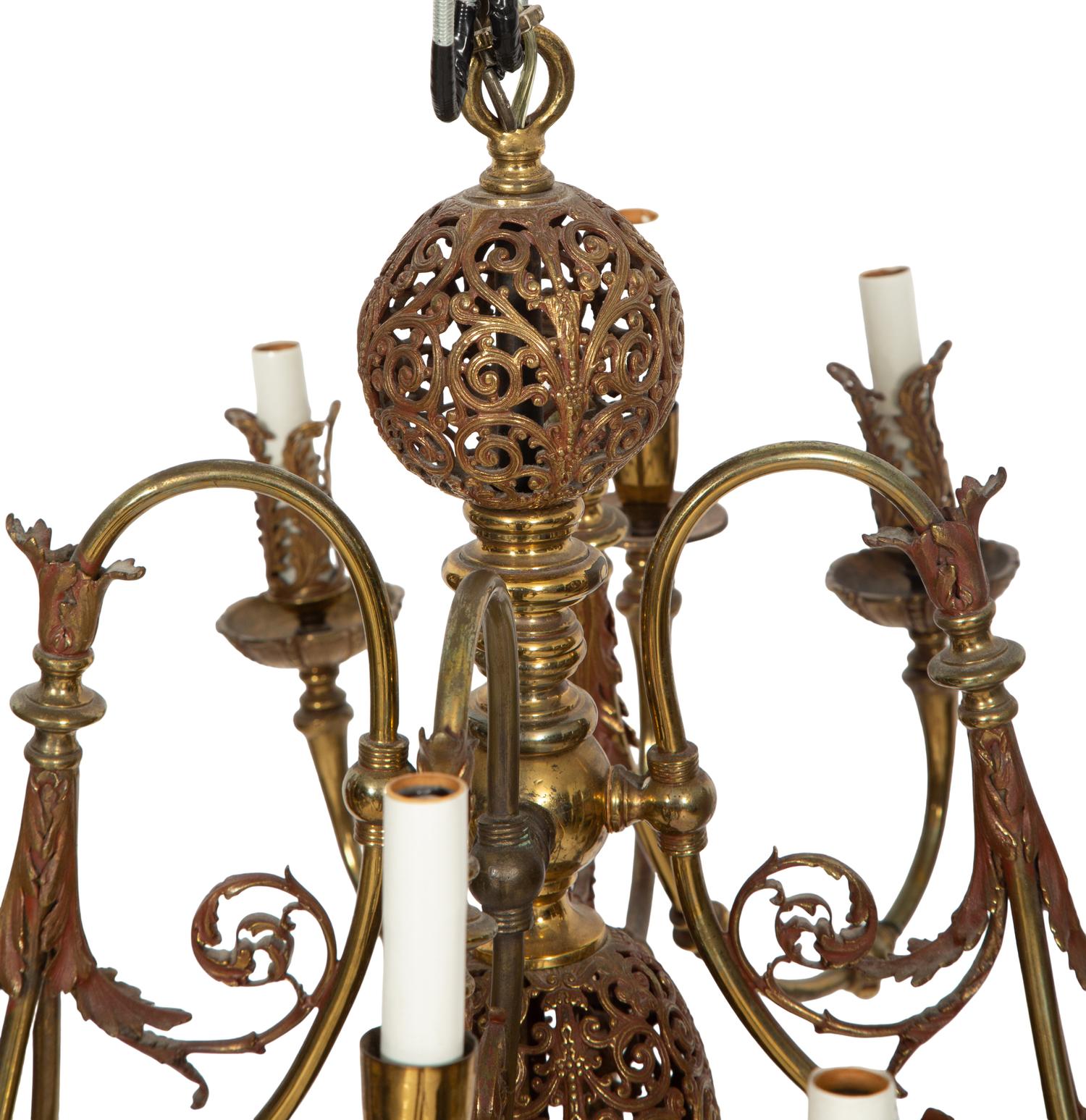 A Pierced Brass Eight-Light Chandelier with Crystal Drops