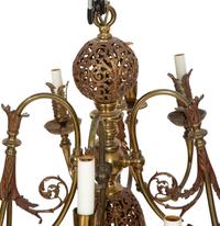 A Pierced Brass Eight-Light Chandelier with Crystal Drops
