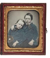 [EARLY PHOTOGRAPHY]. Sixth plate daguerreotype portrait of a pair of young brothers wearing blue jackets and embracing in a loving pose.