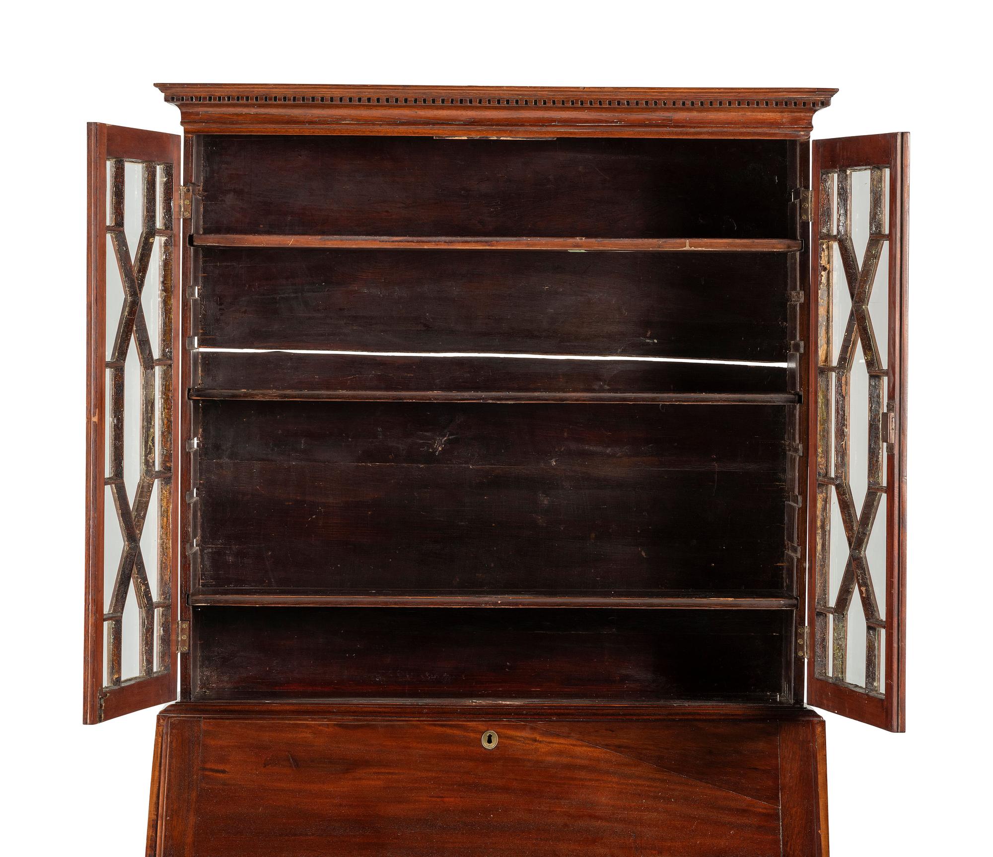 A Chippendale Mahogany and Cherrywood Serpentine Claw-and-Ball Foot Desk-and-Bookcase