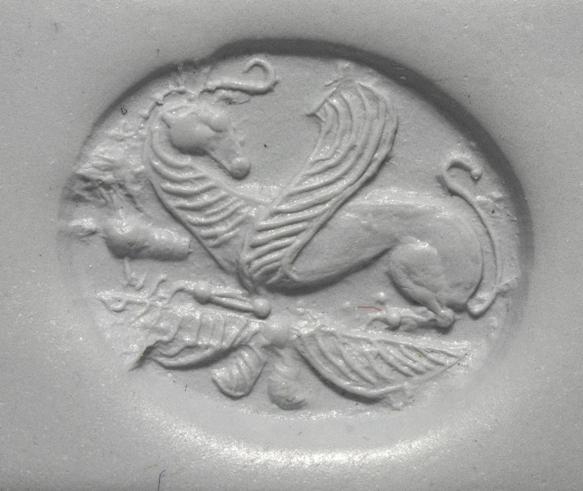 A Greco-Persian Onyx Scaraboid with a Griffin and Winged Sun Disc