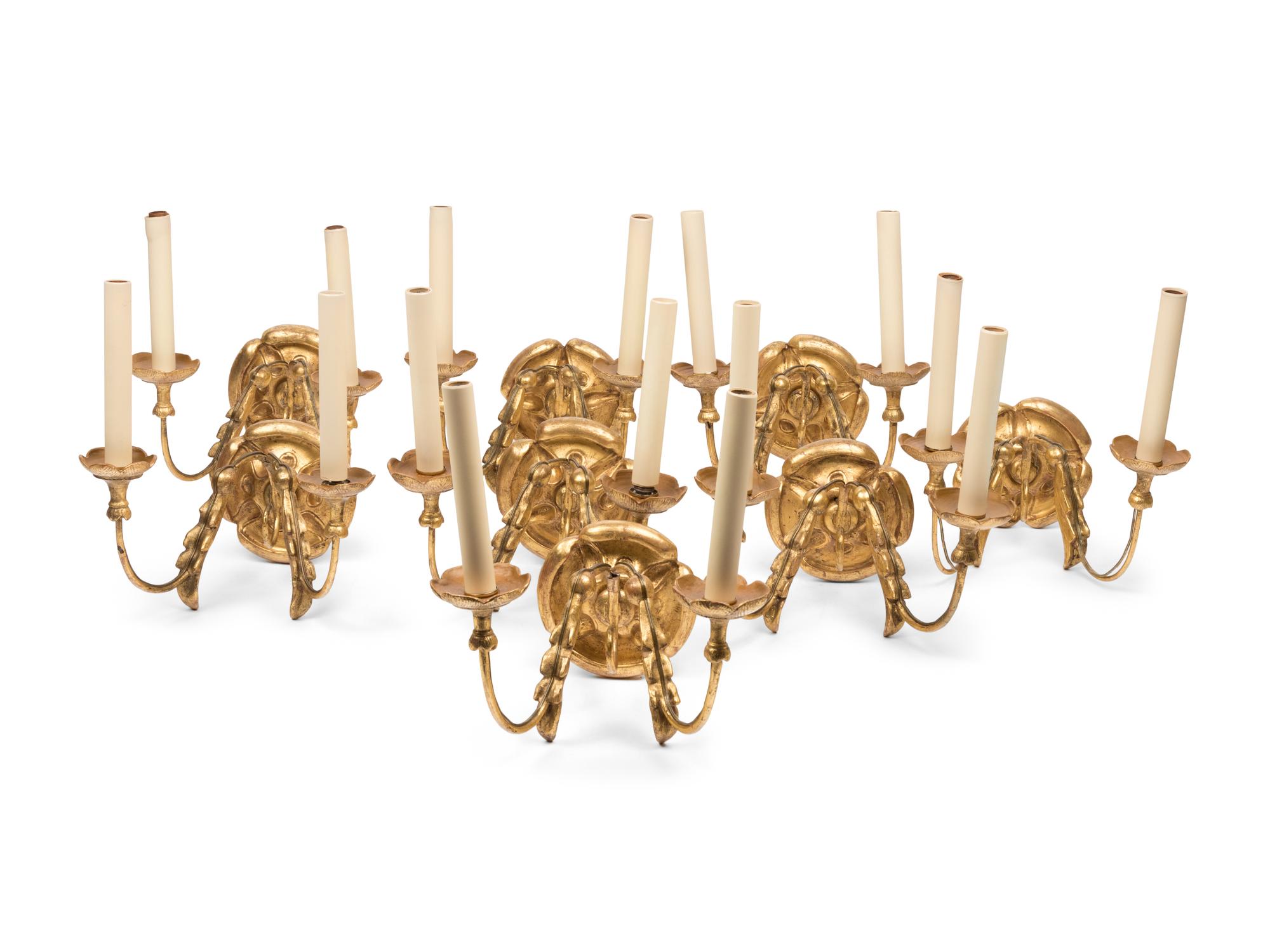 A Set of Eight Continental Giltwood Three-Light Sconces