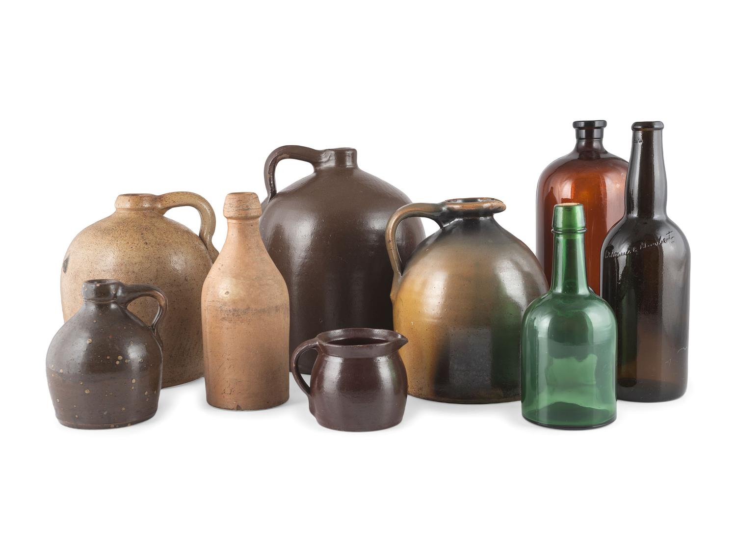 A Group of Stoneware Jugs and Glass Bottles