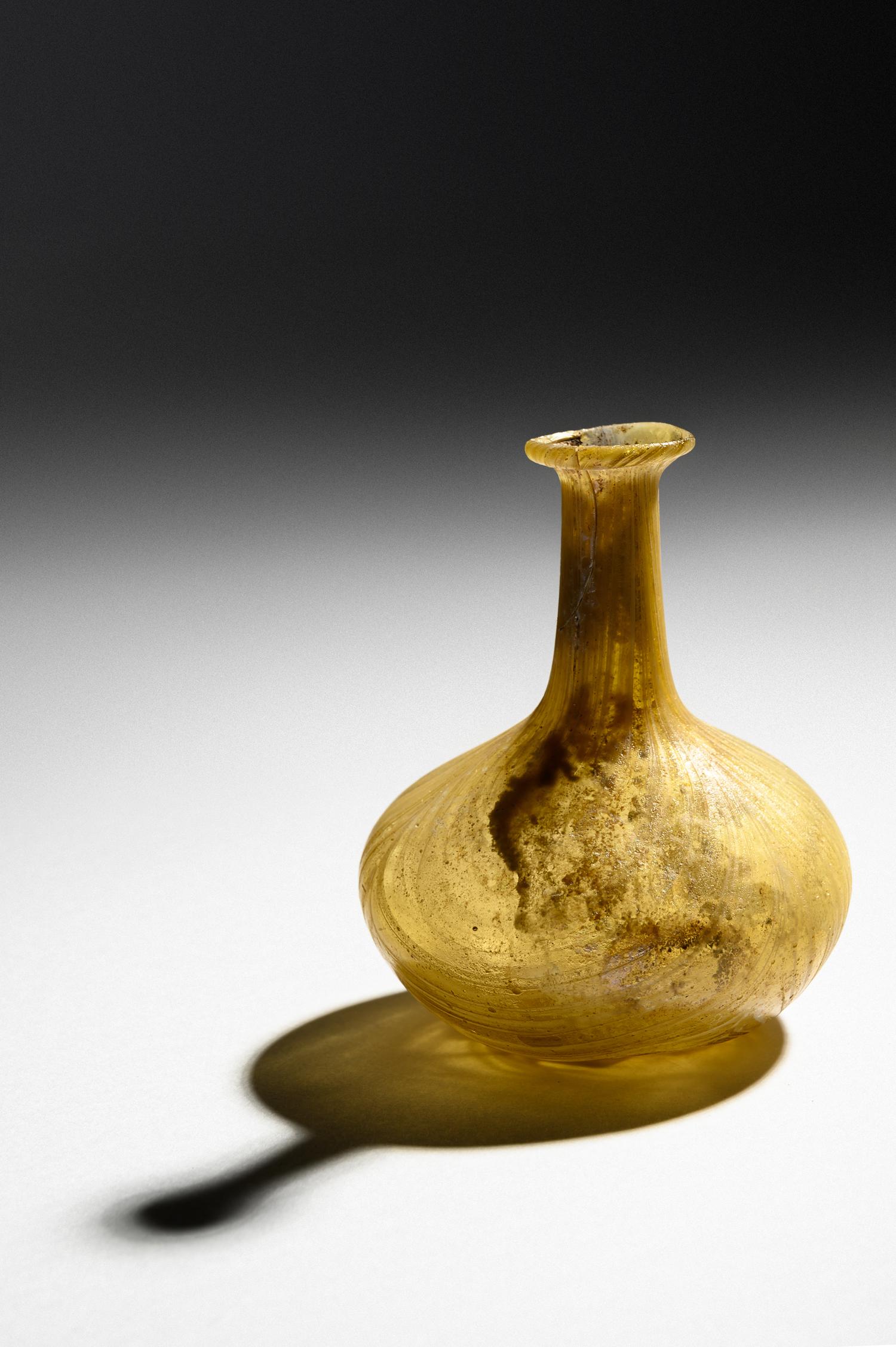 A Roman Marbled Yellow Glass Bottle