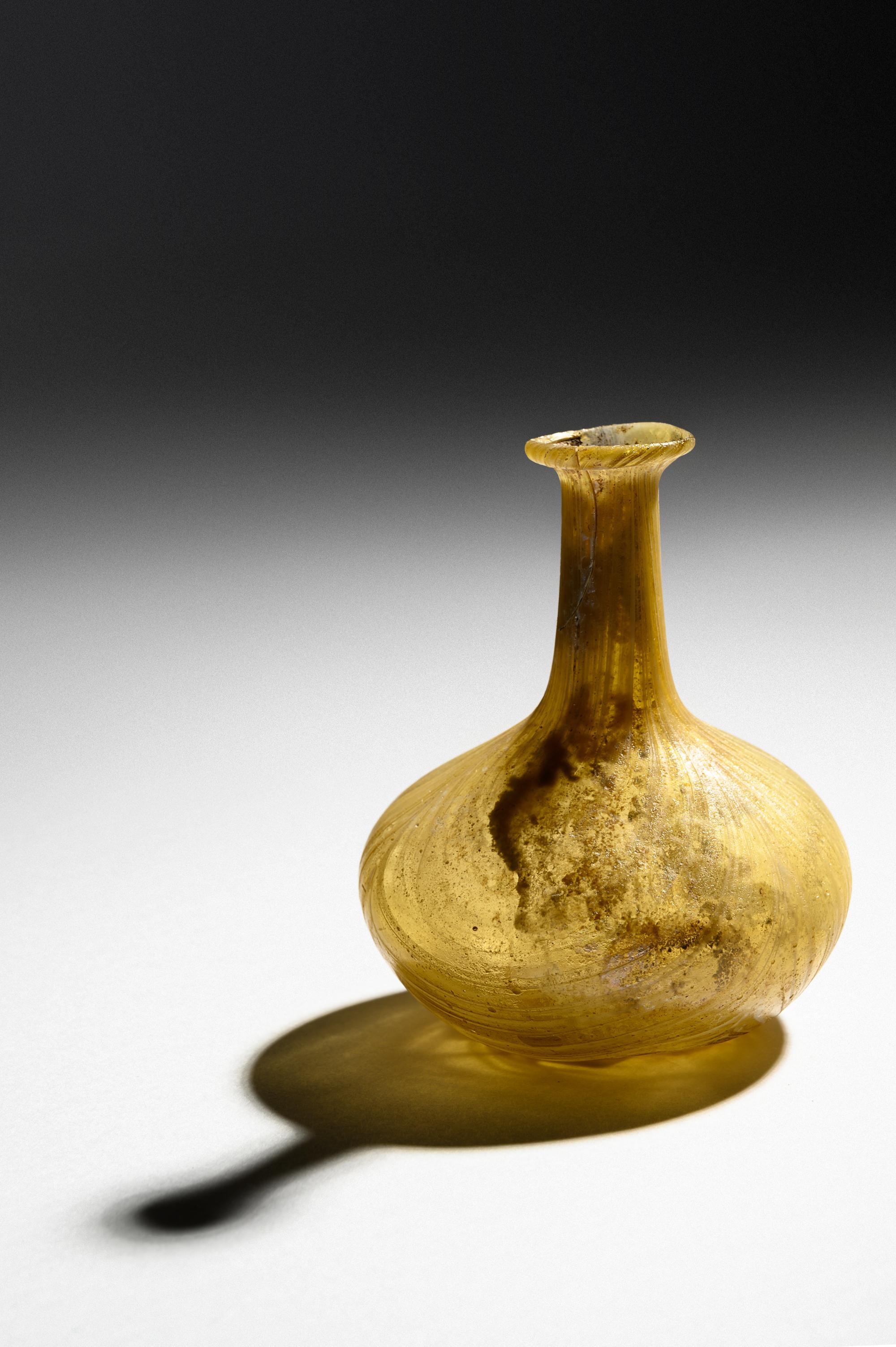 A Roman Marbled Yellow Glass Bottle