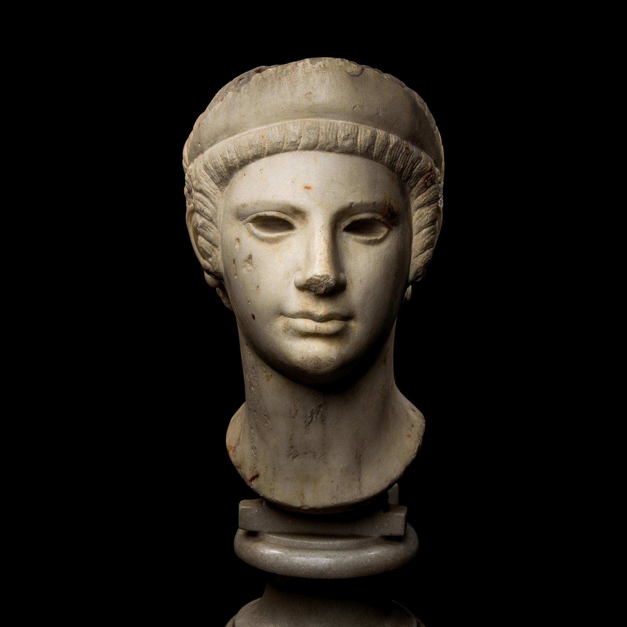 A Roman Marble Archaistic Head of a Goddess