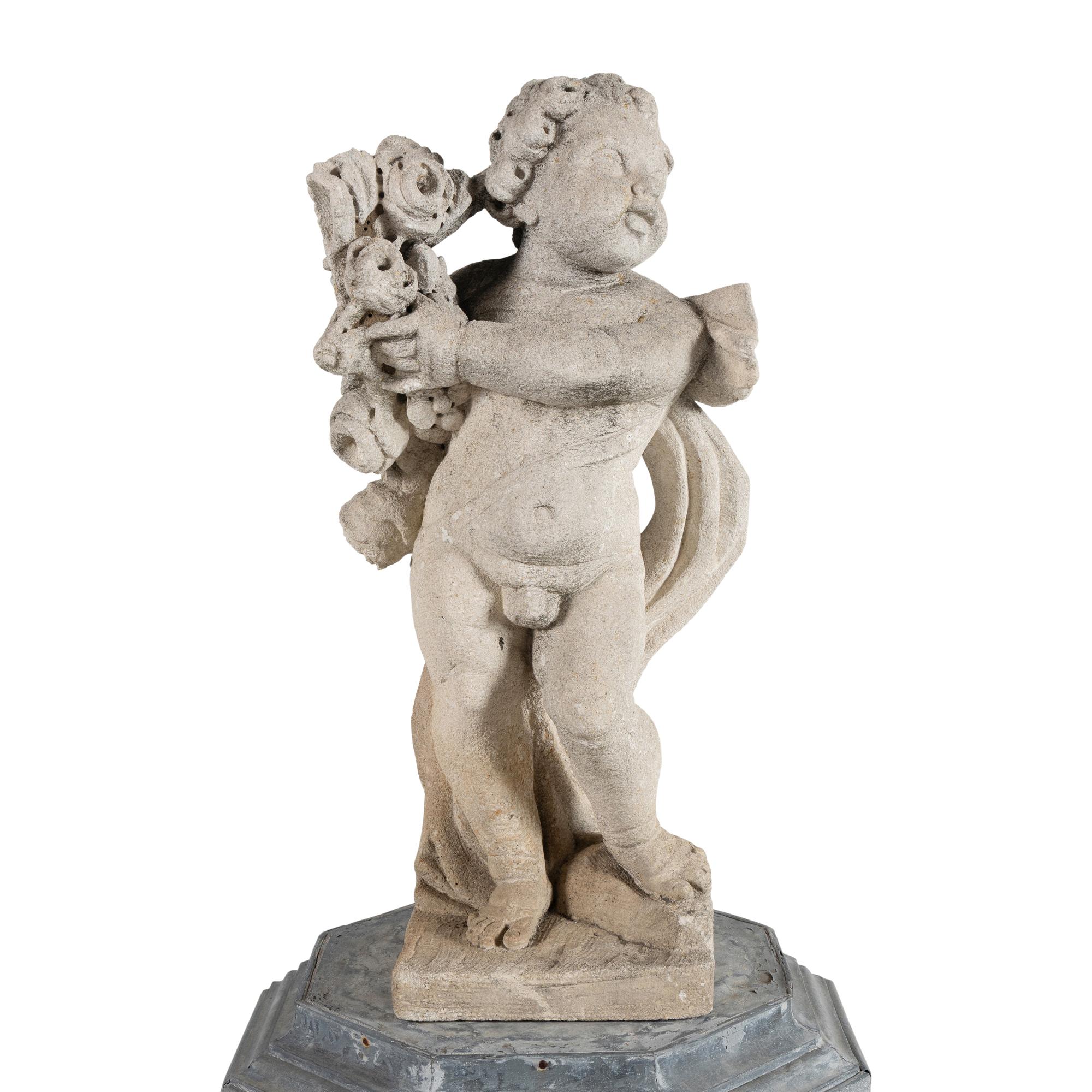 A Cast Stone Garden Figure of a Putto on a Zinc Pedestal