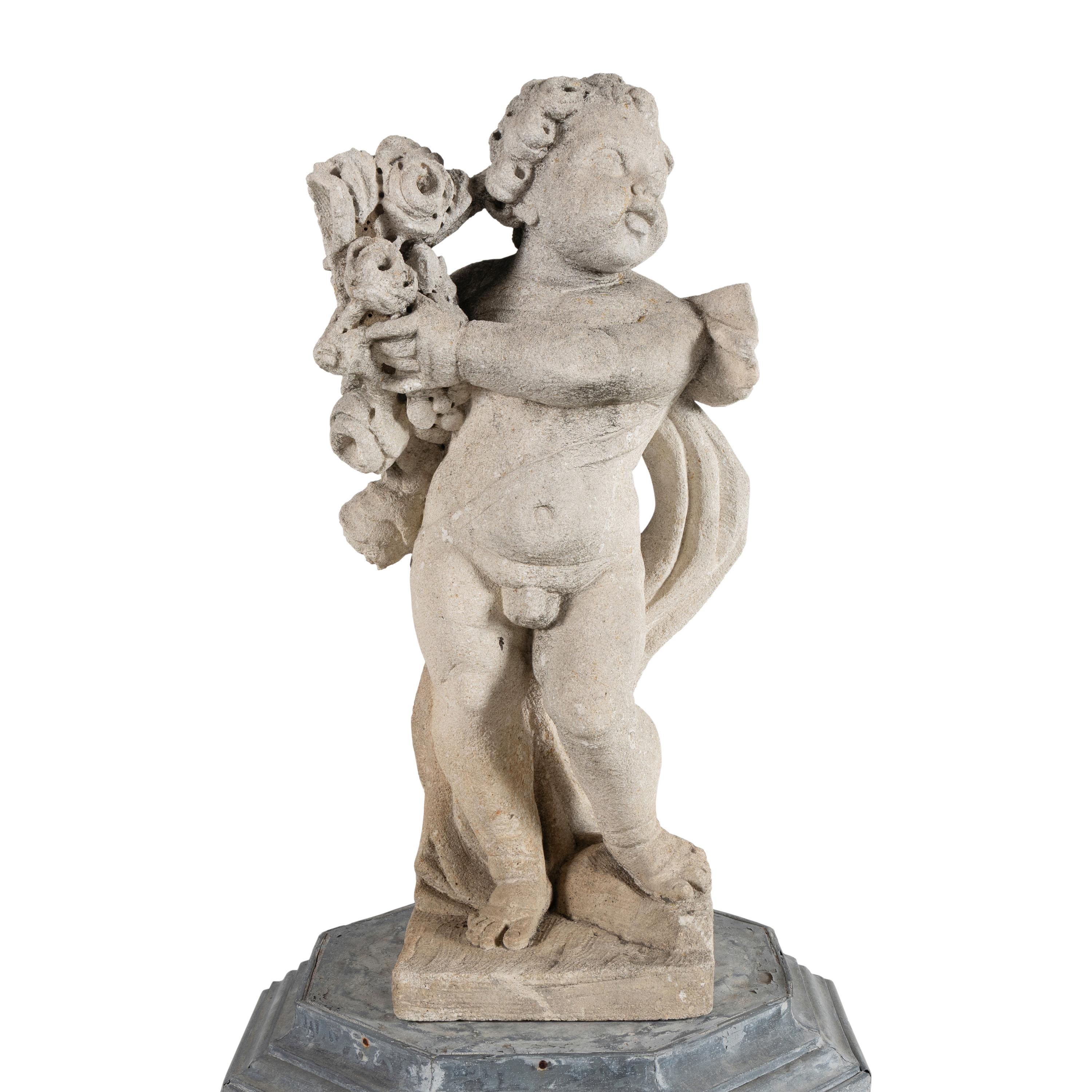 A Cast Stone Garden Figure of a Putto on a Zinc Pedestal
