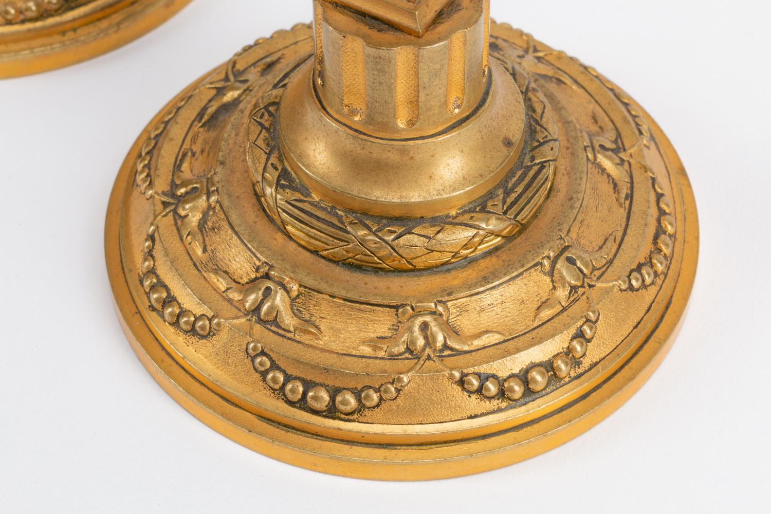 A Pair of Continental Gilt Metal Candlesticks with Busts of Children