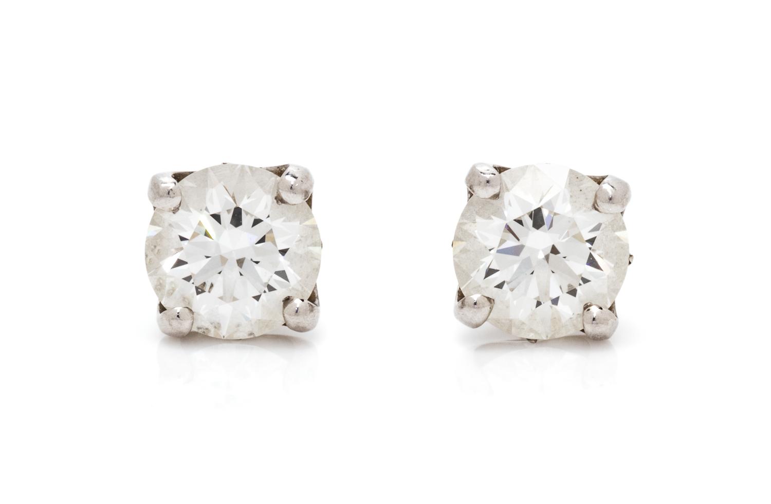 A Pair of Platinum and Diamond 'DB Signature' Stud Earrings, De Beers, 1.35 dwts.