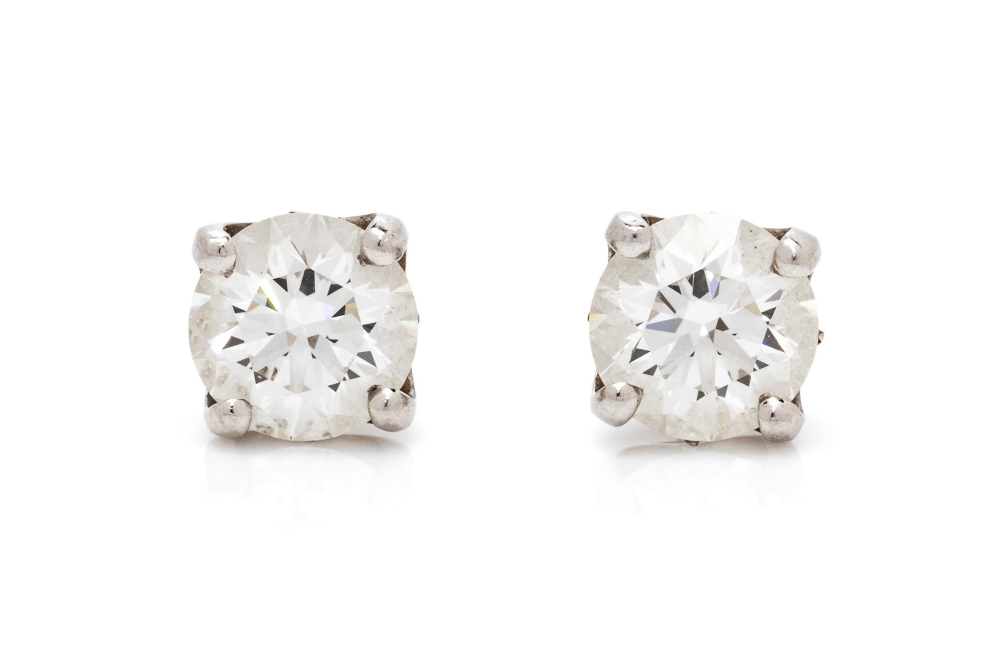 A Pair of Platinum and Diamond 'DB Signature' Stud Earrings, De Beers, 1.35 dwts.