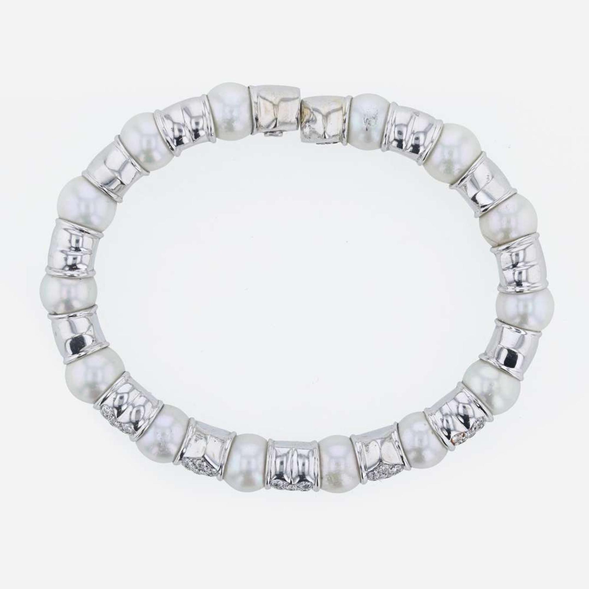 An 18K white gold, cultured pearl, and diamond bangle Italy