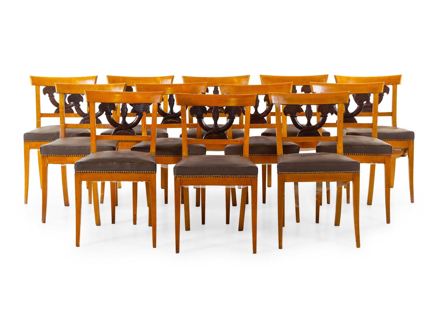 A Set of Twelve Biedermeier Style Parcel Ebonized Birch Dining Chairs