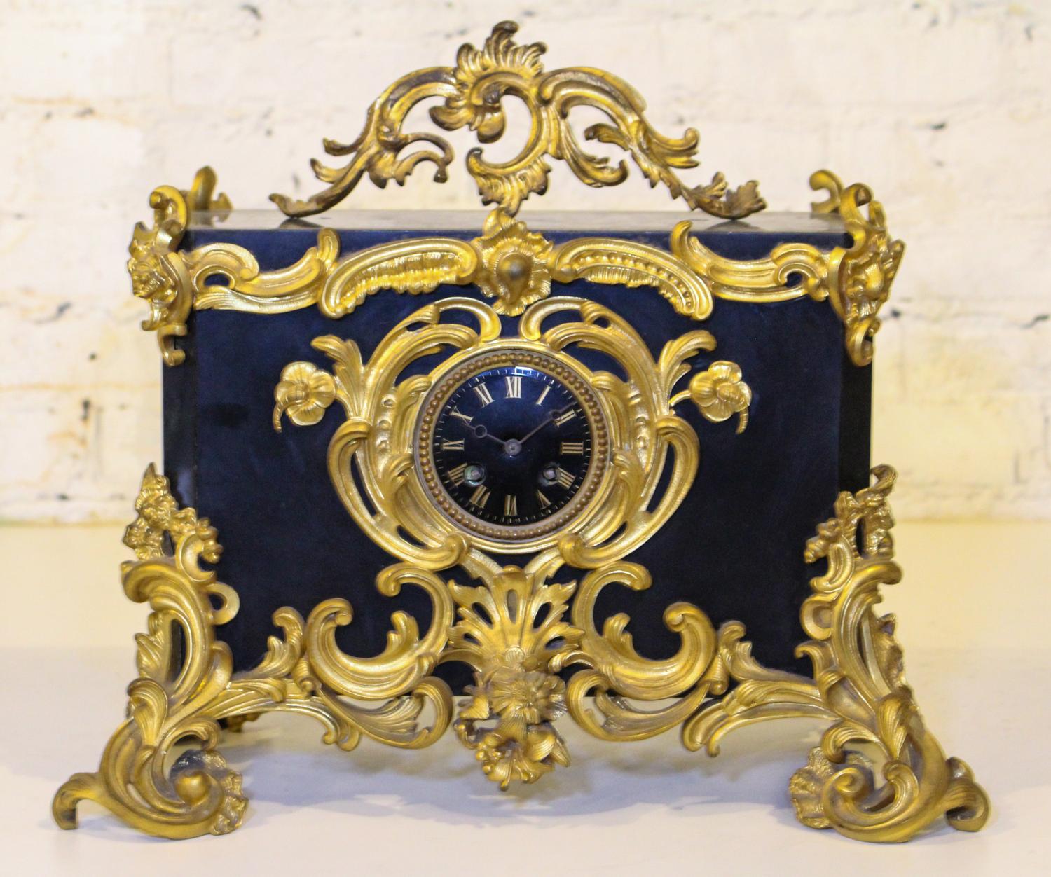 A Victorian Bronze and Slate Mantel Clock. Width 18 inches.