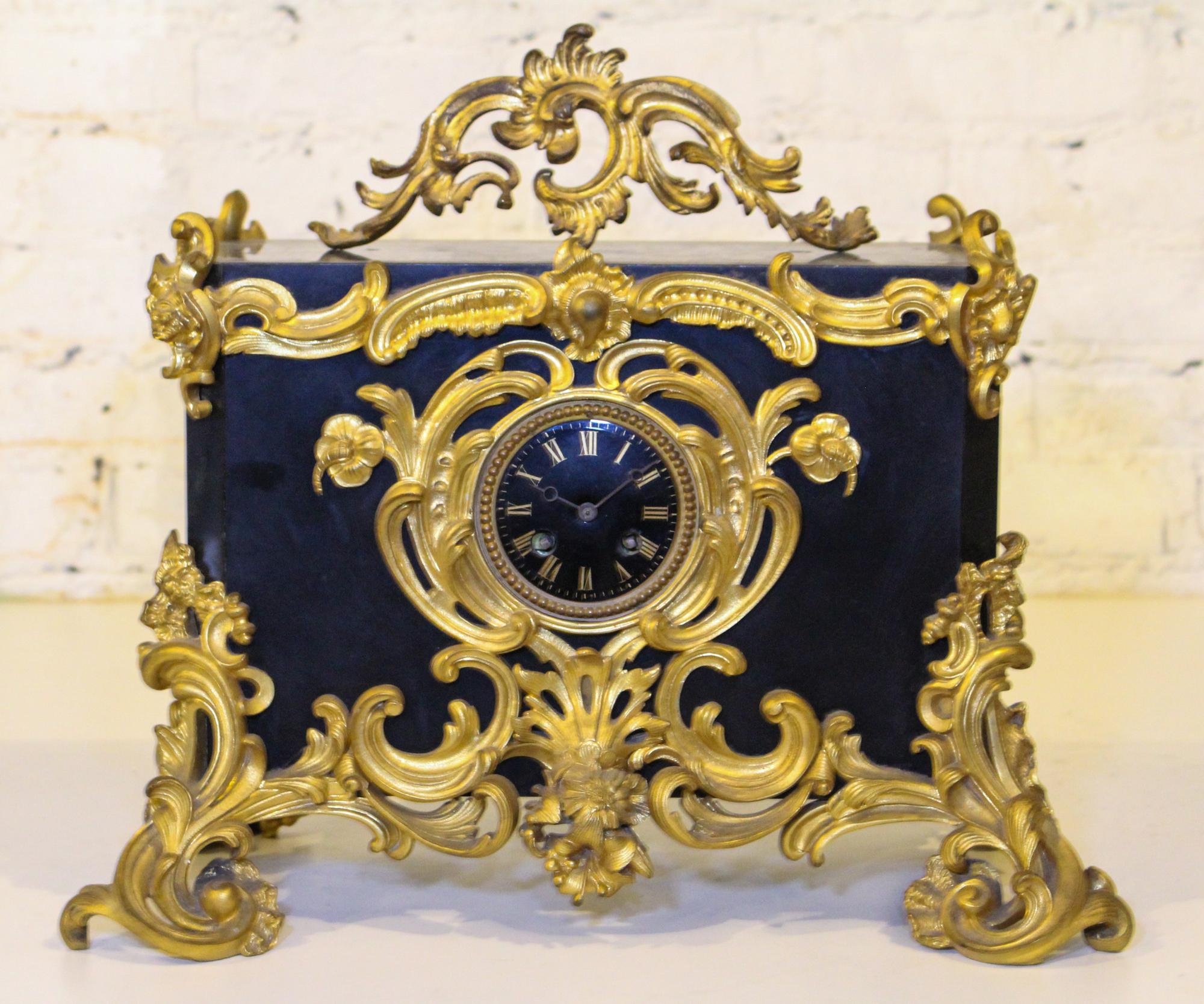 A Victorian Bronze and Slate Mantel Clock. Width 18 inches.