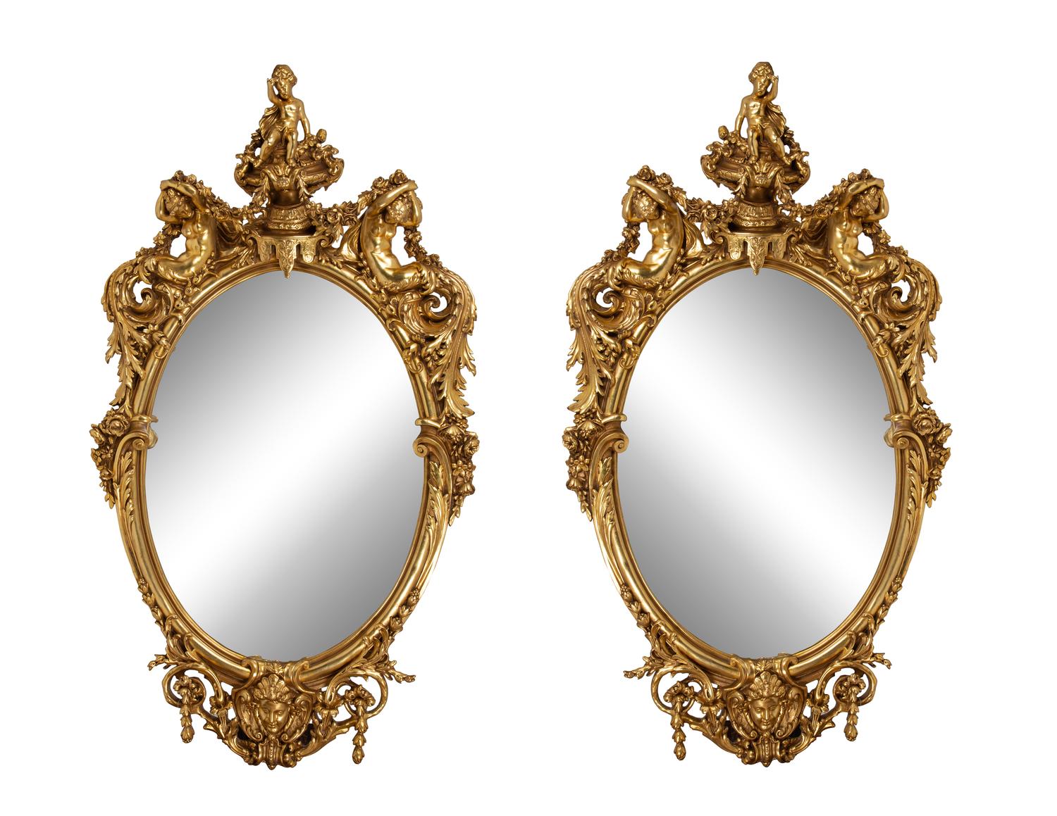 A Pair of Italian Baroque Carved Giltwood Oval Mirrors — 19TH CENTURY