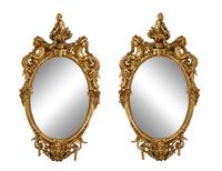 A Pair of Italian Baroque Carved Giltwood Oval Mirrors — 19TH CENTURY