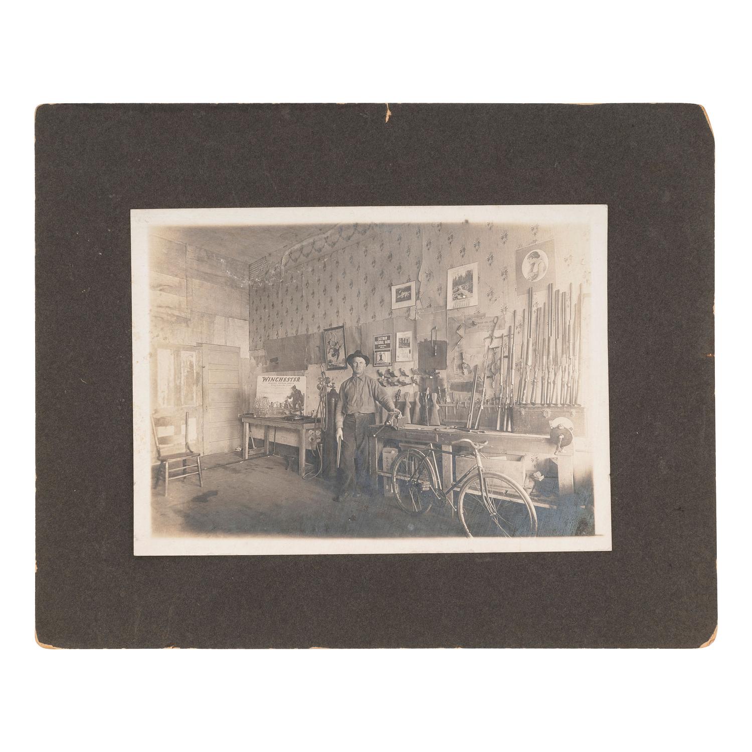 [GUNS]. Interior portrait of a gunsmith in his workshop. N.p.: N.p., 1 January 1921.