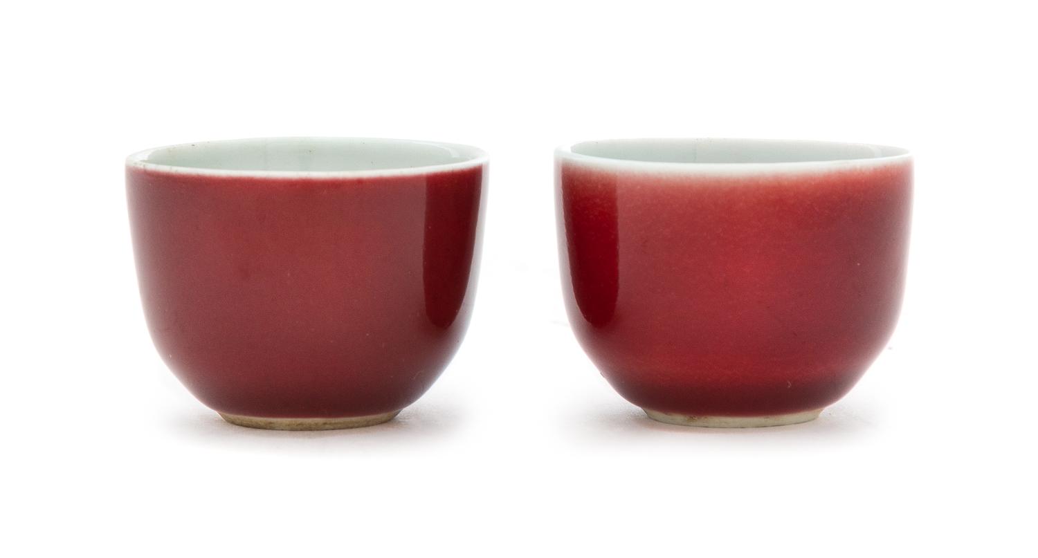 A Pair of Chinese Sang-de-Boeuf Glazed Porcelain Cups Diameter of each 1 3/4 inches. — 18TH CENTURY
