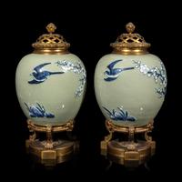 A Pair of Chinese Celadon Ground Blue and White Porcelain Jars with Later Ormolu Mounts, Porcelain: Kangxi Period, Mounts: Late 19th/Early 20th Century 銅鎏金鑲清康熙豆青地青花喜上眉梢圖罐一對