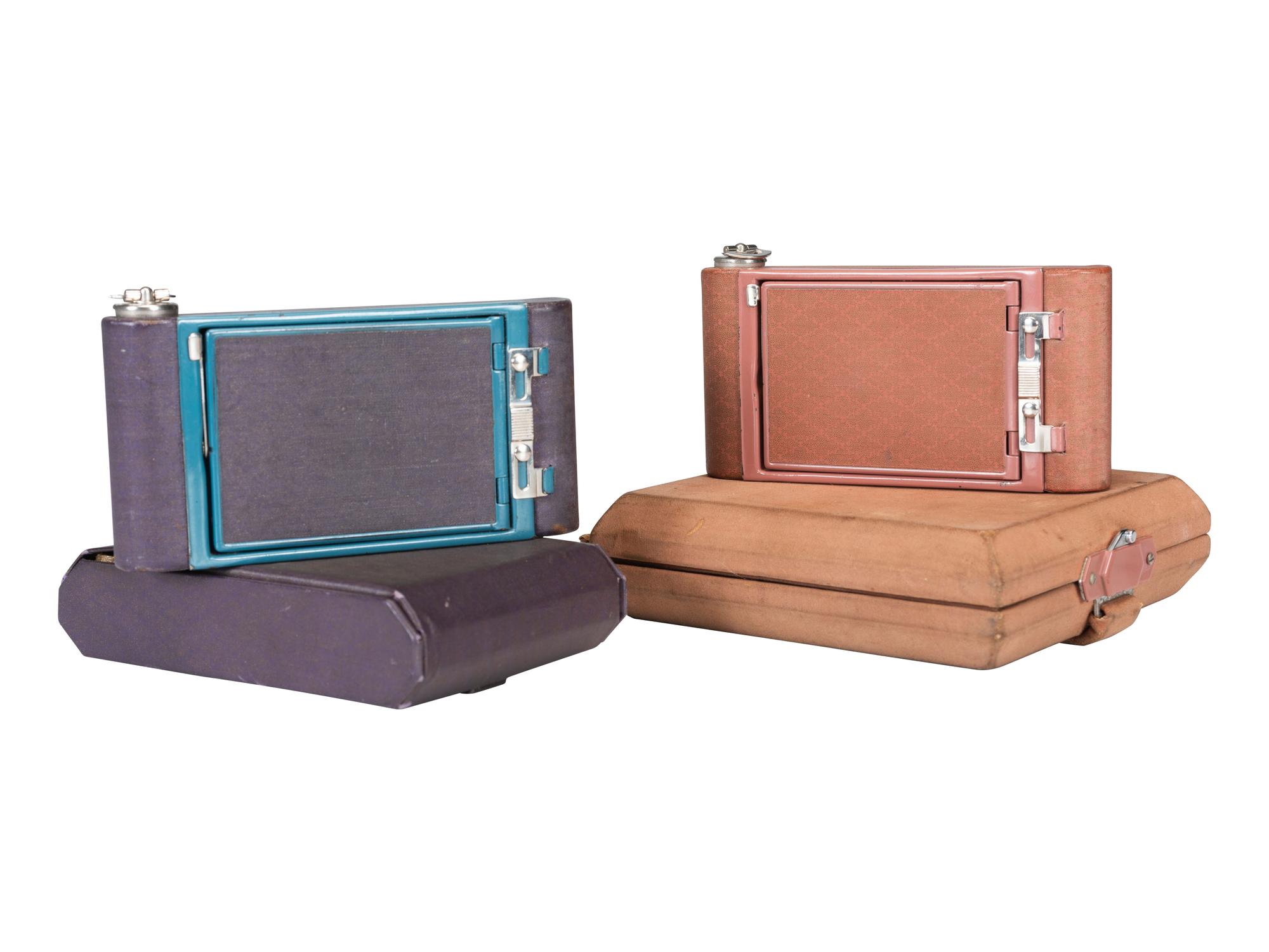 [EARLY PHOTOGRAPHY]. Two Kodak Petite Cameras, one with original vanity case.