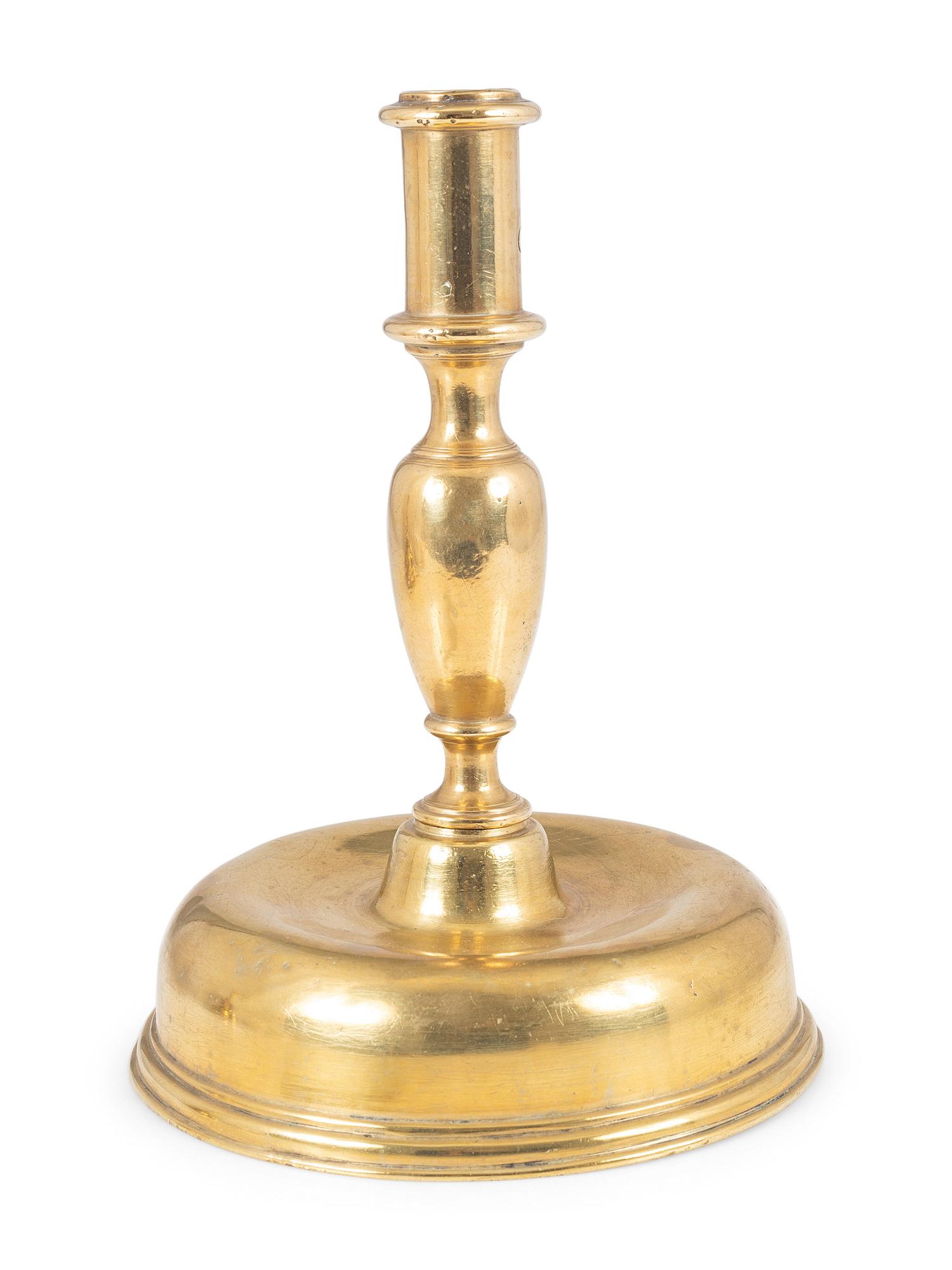 A Continental Brass Bell-Bottom Candlestick