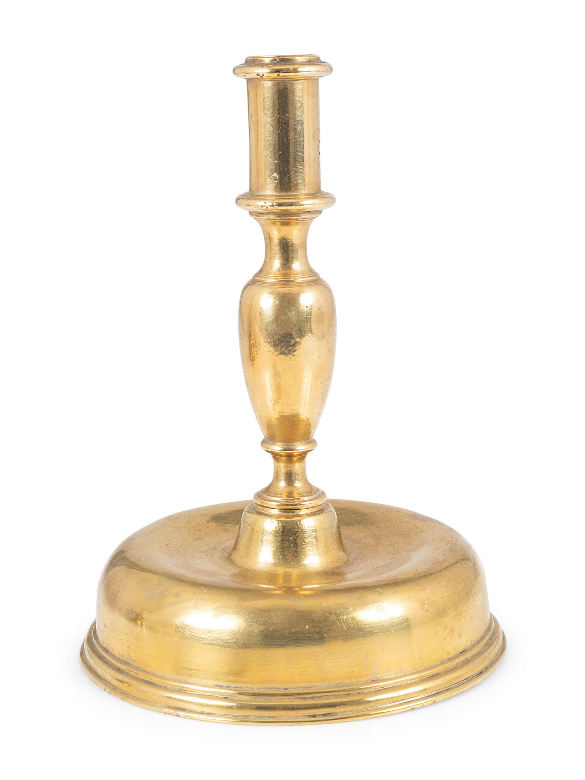 A Continental Brass Bell-Bottom Candlestick