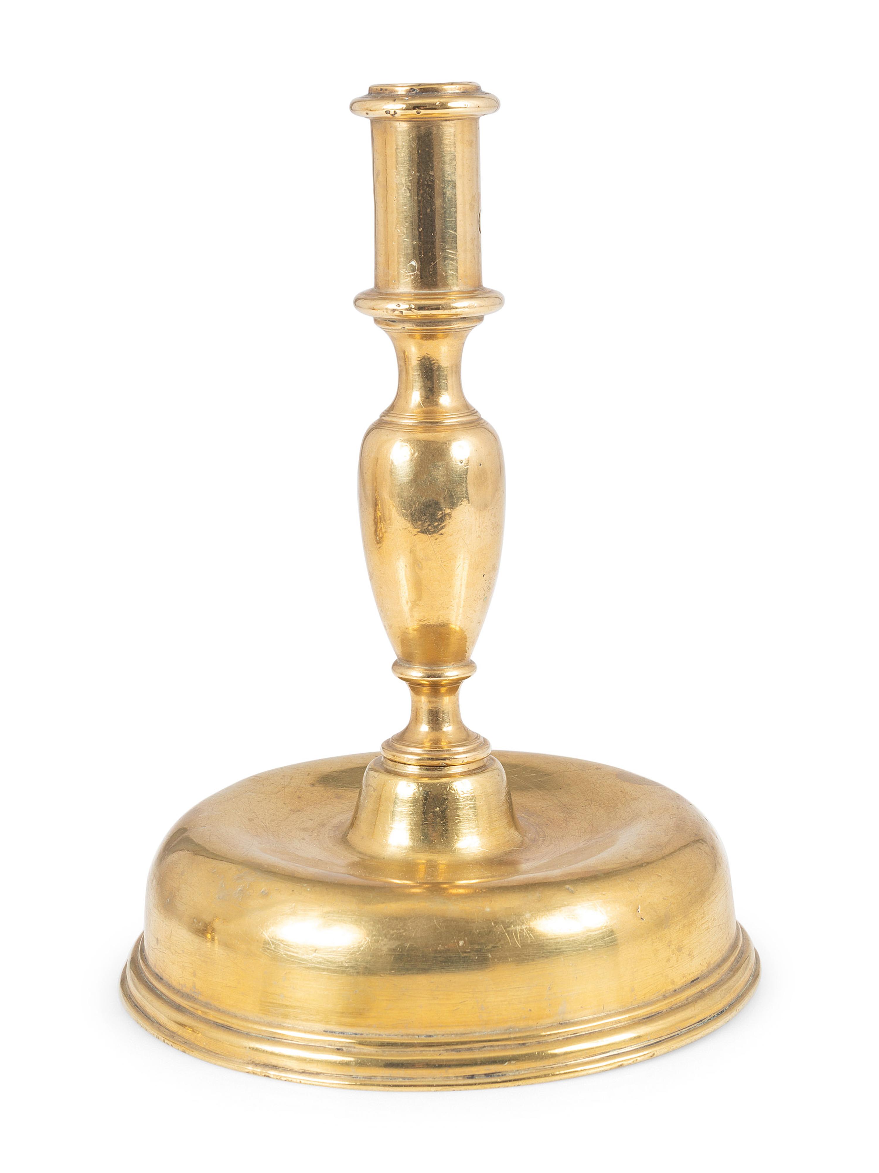 A Continental Brass Bell-Bottom Candlestick