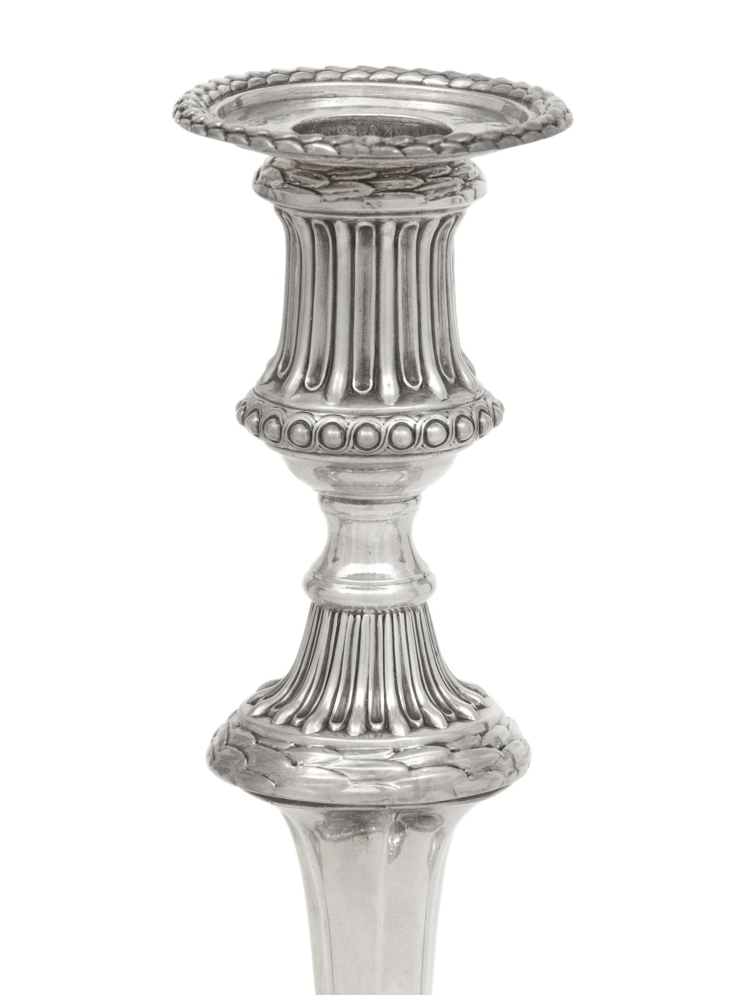 A Set of Three George III Silver Candlesticks