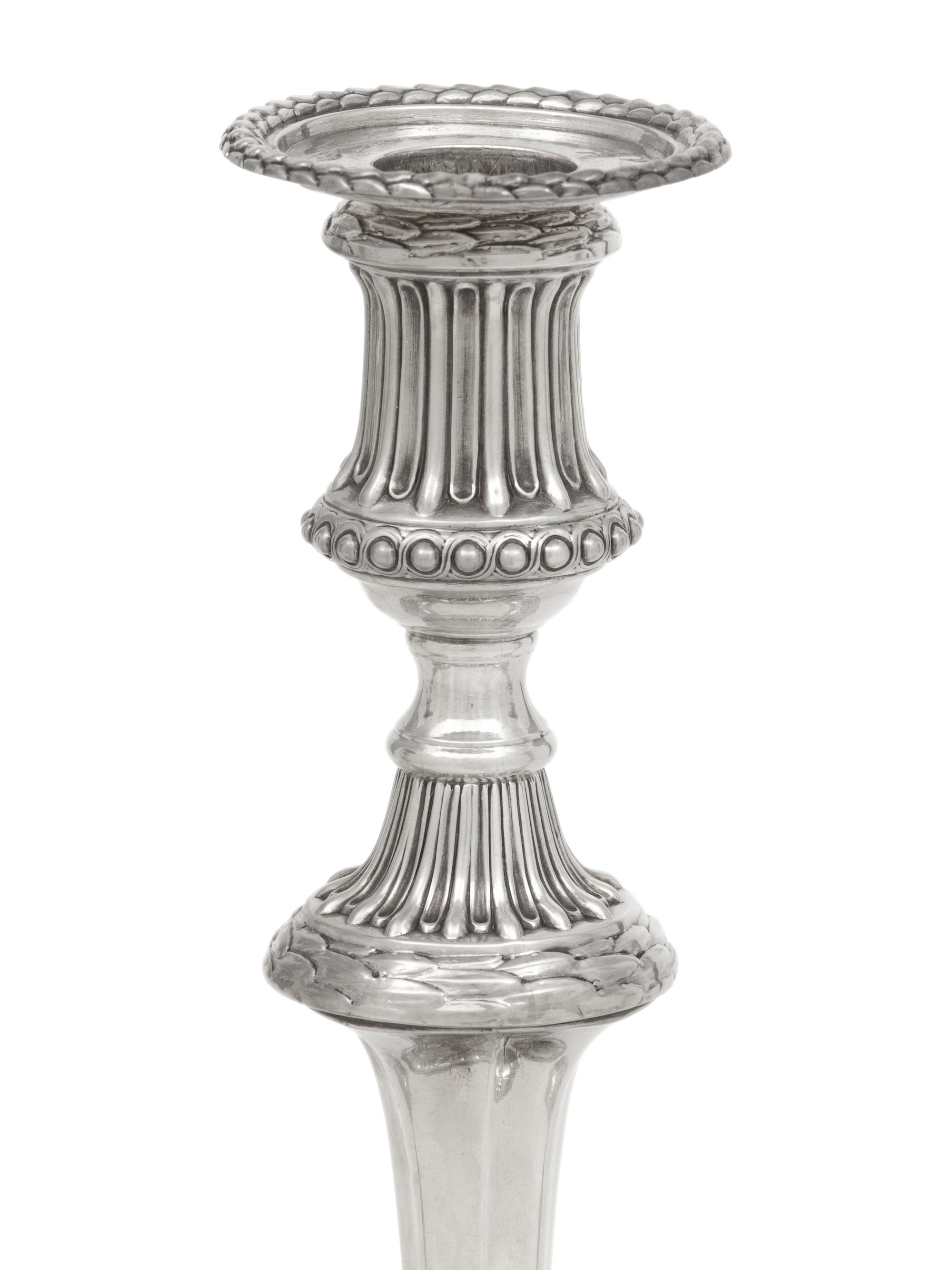 A Set of Three George III Silver Candlesticks