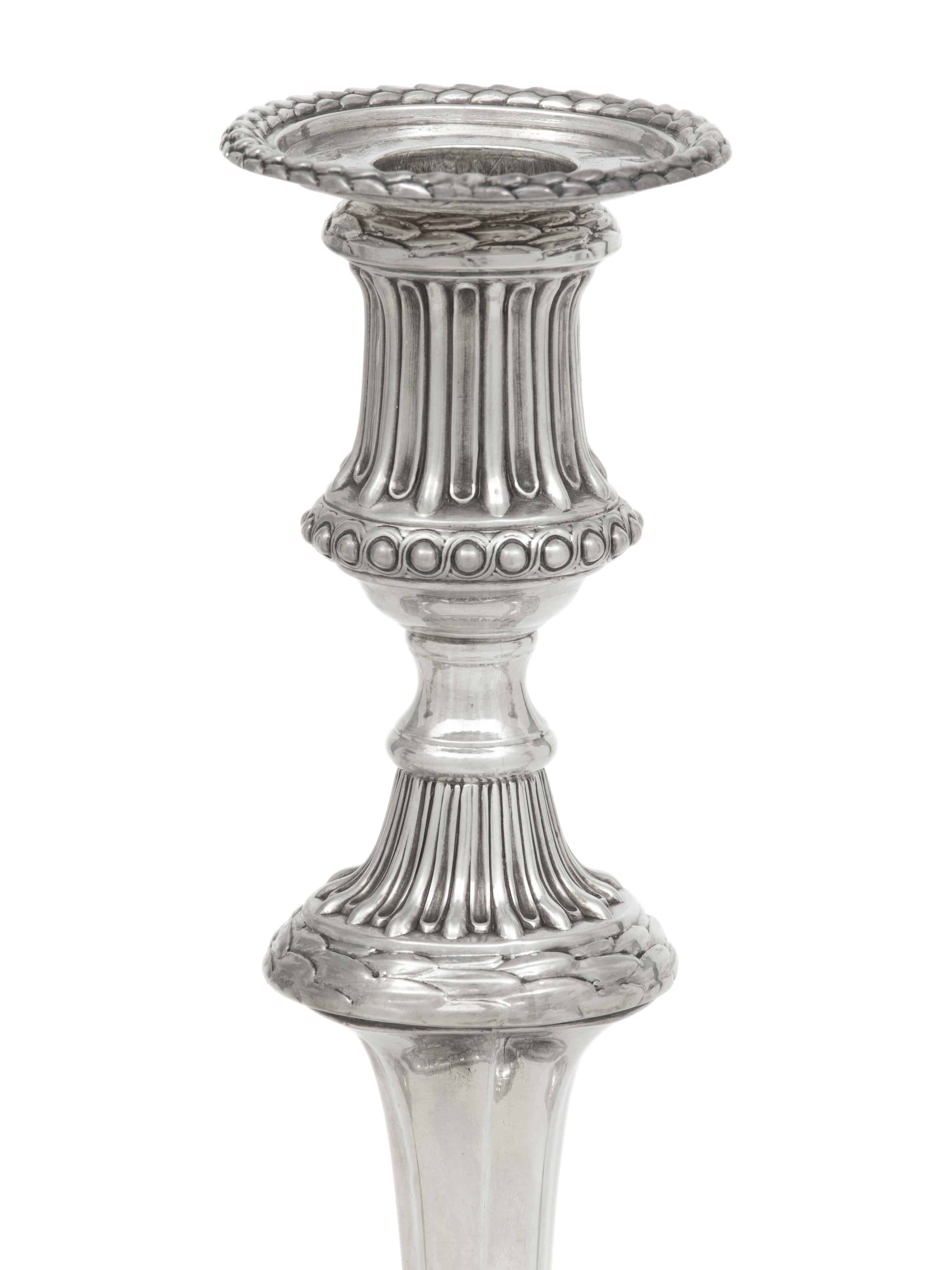 A Set of Three George III Silver Candlesticks