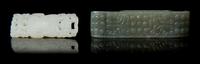 Two Carved Jade Sword Slides Length of larger 2 3/4 inches.