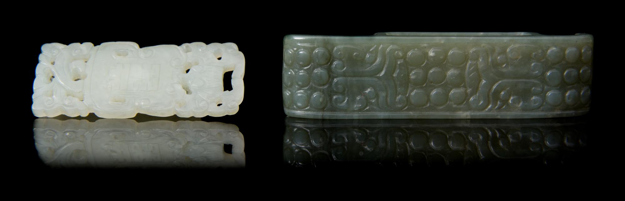 Two Carved Jade Sword Slides Length of larger 2 3/4 inches.